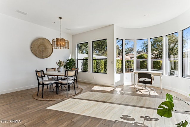 dining room featuring hardwood / wood-style flooring and a notable chandelier