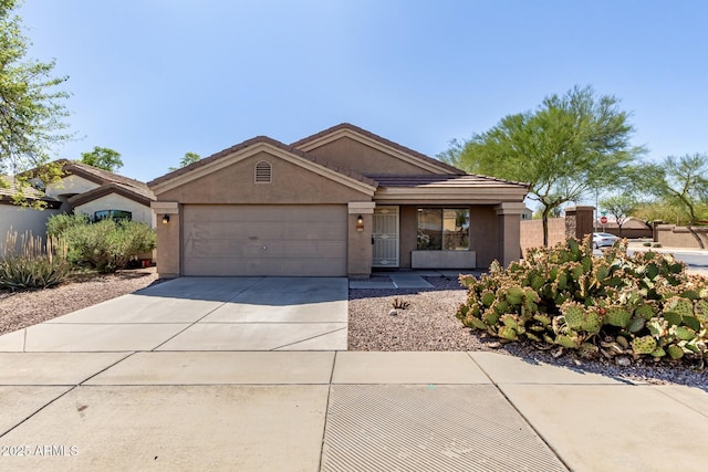 ranch-style house featuring concrete driveway, an attached garage, fence, and stucco siding