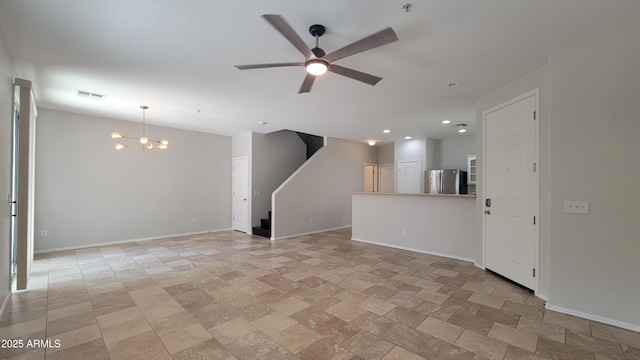 unfurnished living room featuring visible vents, ceiling fan with notable chandelier, stairway, and baseboards