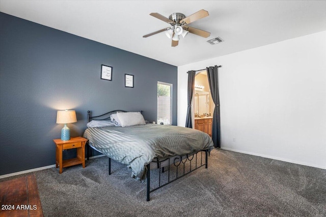 bedroom with connected bathroom, visible vents, ceiling fan, and baseboards