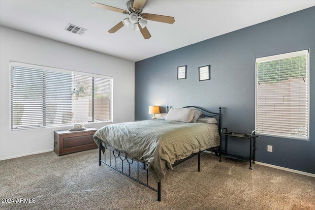 bedroom featuring a ceiling fan, baseboards, visible vents, and carpet flooring