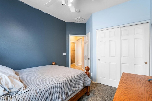 bedroom featuring a ceiling fan, visible vents, dark carpet, and a closet