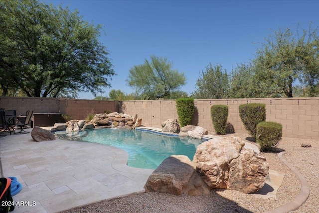 view of pool featuring a patio area and a fenced backyard