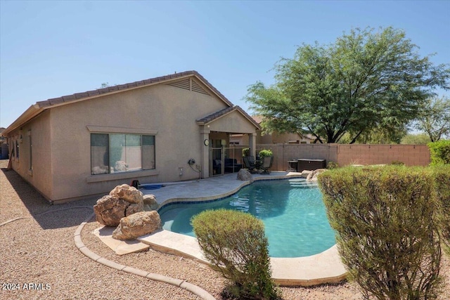 view of pool featuring a patio area, fence private yard, a jacuzzi, and a fenced in pool