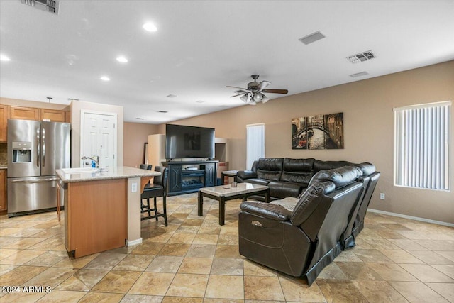 living area featuring ceiling fan, visible vents, and recessed lighting