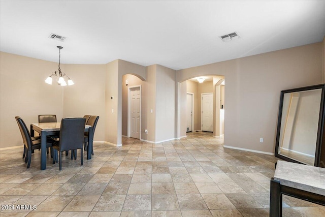 dining room featuring an inviting chandelier, baseboards, visible vents, and arched walkways