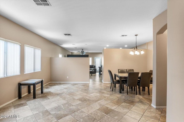 dining room featuring visible vents, baseboards, and ceiling fan with notable chandelier