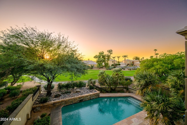 view of pool at dusk