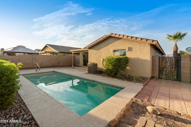 view of swimming pool with central AC unit