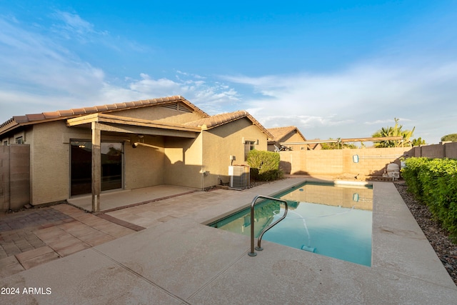 view of pool with a patio and central AC unit