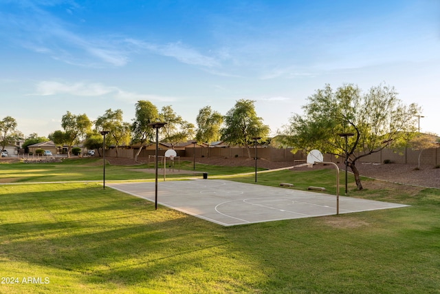 view of basketball court featuring a yard