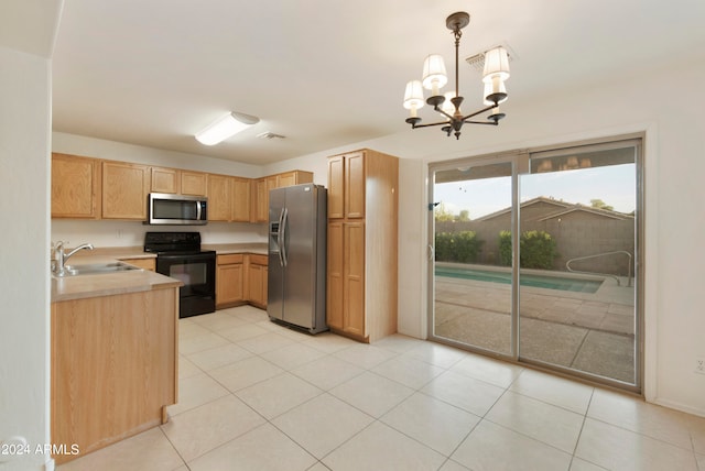 kitchen with appliances with stainless steel finishes, sink, light brown cabinets, pendant lighting, and an inviting chandelier