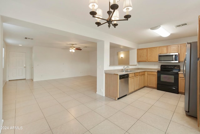 kitchen with ceiling fan with notable chandelier, stainless steel appliances, sink, light tile patterned floors, and hanging light fixtures