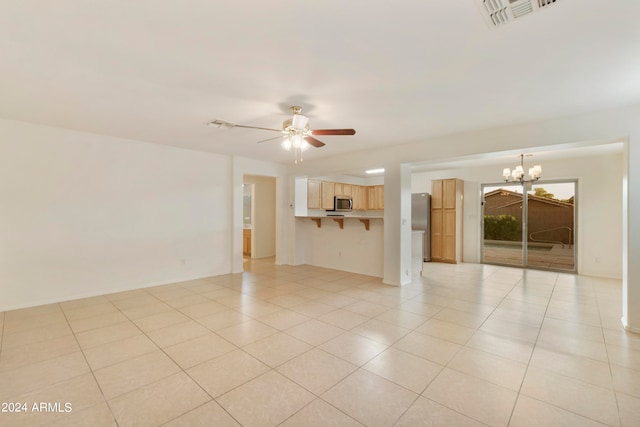 unfurnished living room with light tile patterned flooring and ceiling fan with notable chandelier