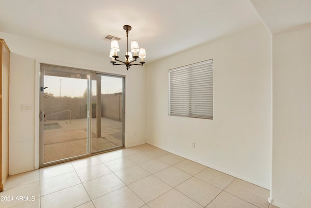 unfurnished room featuring light tile patterned floors and a notable chandelier