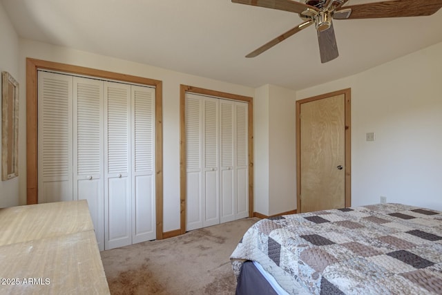 bedroom featuring multiple closets, carpet floors, and ceiling fan