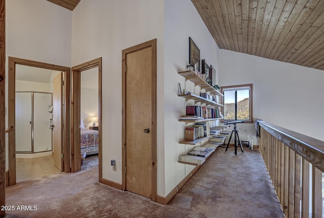 hall featuring wood ceiling, high vaulted ceiling, and carpet