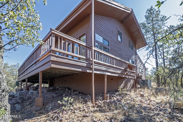 view of property exterior with a deck