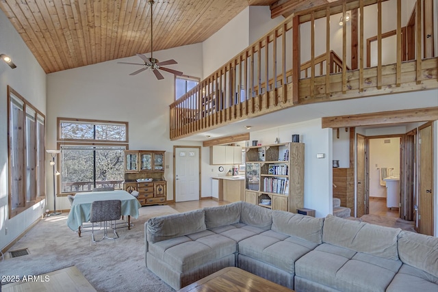 carpeted living room featuring wood ceiling, ceiling fan, and high vaulted ceiling