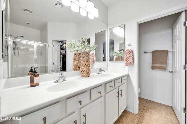 bathroom with walk in shower, vanity, toilet, and tile patterned flooring