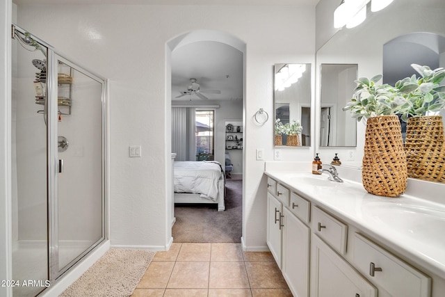 bathroom with vanity, a shower with door, tile patterned floors, and ceiling fan