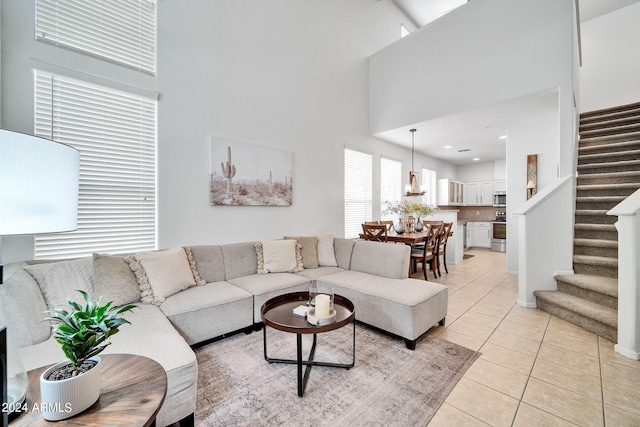 tiled living room with a towering ceiling