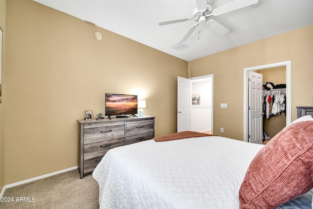 bedroom featuring ceiling fan, carpet flooring, a closet, and a spacious closet