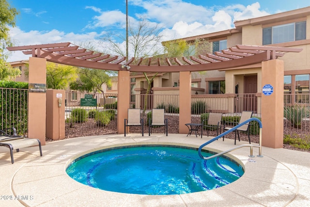 view of pool with a community hot tub, a pergola, and a patio area