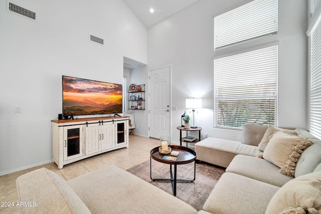 tiled living room with high vaulted ceiling