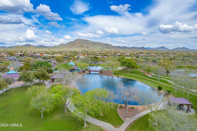 birds eye view of property with a water and mountain view