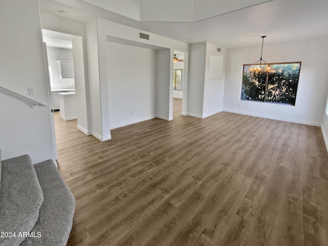 living room featuring hardwood / wood-style floors and ceiling fan with notable chandelier