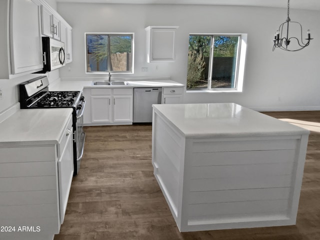 kitchen with white cabinets, decorative light fixtures, sink, and appliances with stainless steel finishes