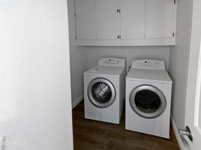 clothes washing area featuring dark hardwood / wood-style floors, cabinets, and independent washer and dryer