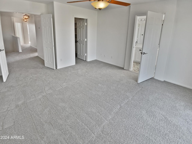 empty room with ceiling fan and light carpet