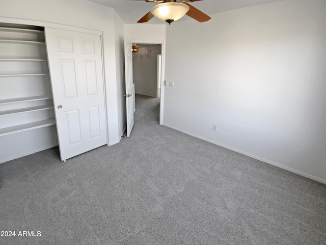 unfurnished bedroom with carpet flooring, ceiling fan, and a closet