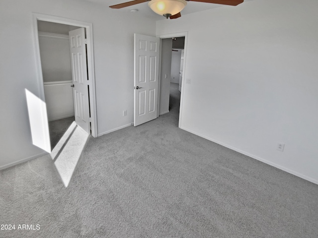 unfurnished bedroom with ceiling fan, a closet, and light carpet