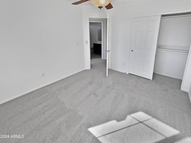 unfurnished bedroom featuring ceiling fan, a closet, and carpet floors