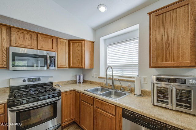 4369 E Coal St, San Tan Valley, AZ 85143 - kitchen with appliances with stainless steel finishes, lofted ceiling, light countertops, brown cabinets, and recessed lighting