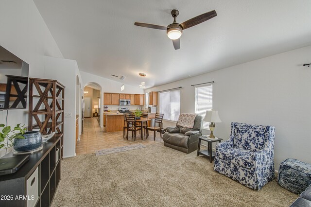 4369 E Coal St, San Tan Valley, AZ 85143 - living area with arched walkways, vaulted ceiling, ceiling fan, and light colored carpet