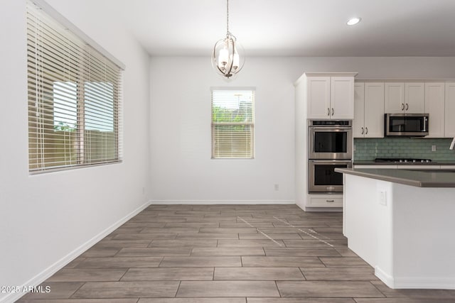 20499 W Alsap Rd, Buckeye, AZ 85396 - kitchen with appliances with stainless steel finishes, light wood-type flooring, white cabinets, recessed lighting, and backsplash