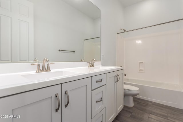 20499 W Alsap Rd, Buckeye, AZ 85396 - bathroom with toilet, double vanity, tub / shower combination, and wood finished floors
