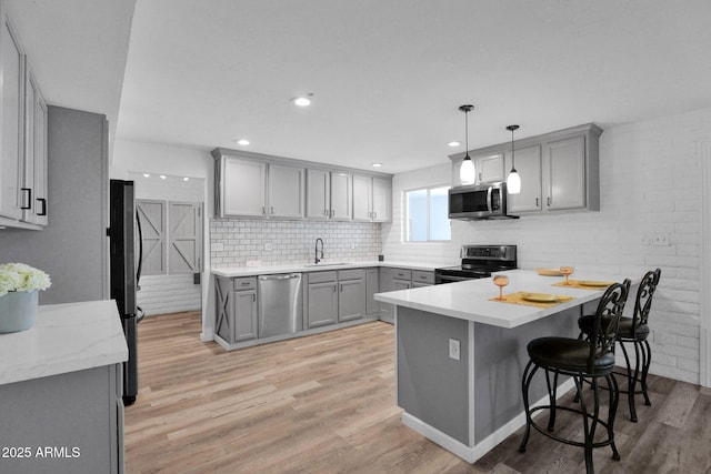 29835 N 56th St N, Cave Creek, AZ 85331 - kitchen with stainless steel appliances, gray cabinets, a sink, a peninsula, and recessed lighting