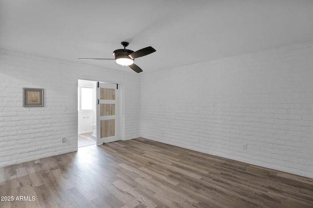 29835 N 56th St N, Cave Creek, AZ 85331 - empty room featuring brick wall, wood finished floors, and a ceiling fan