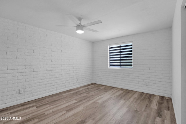29835 N 56th St N, Cave Creek, AZ 85331 - spare room with wood finished floors, baseboards, brick wall, and ceiling fan