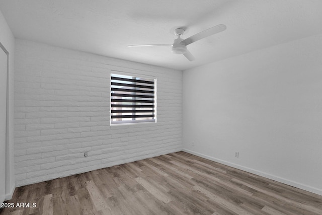 29835 N 56th St N, Cave Creek, AZ 85331 - spare room with wood finished floors, brick wall, a ceiling fan, and baseboards