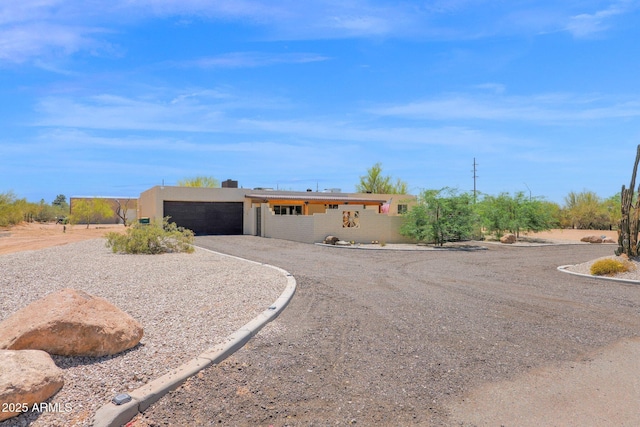 29835 N 56th St N, Cave Creek, AZ 85331 - view of front of home featuring dirt driveway, an attached garage, and stucco siding