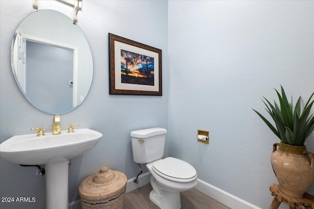 bathroom featuring hardwood / wood-style floors and toilet