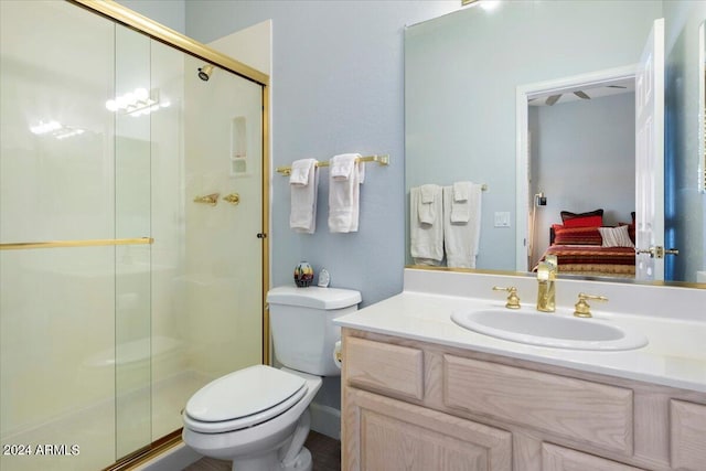 bathroom featuring an enclosed shower, vanity, and toilet