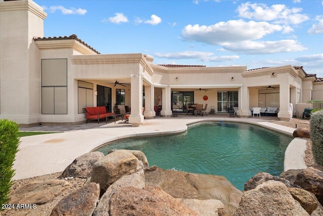 view of pool featuring a patio, outdoor lounge area, and ceiling fan