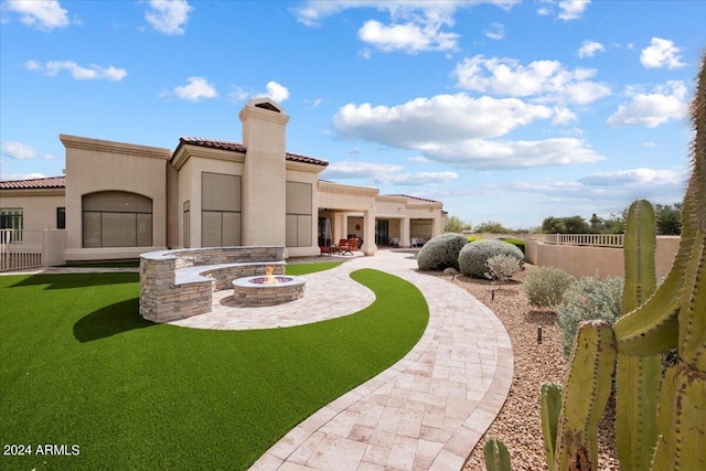 exterior space with a patio and a fire pit